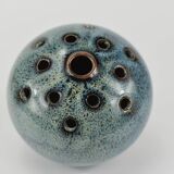 Vase with blue flowers.