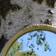 Miroir ovale fleurs sculptées doré
