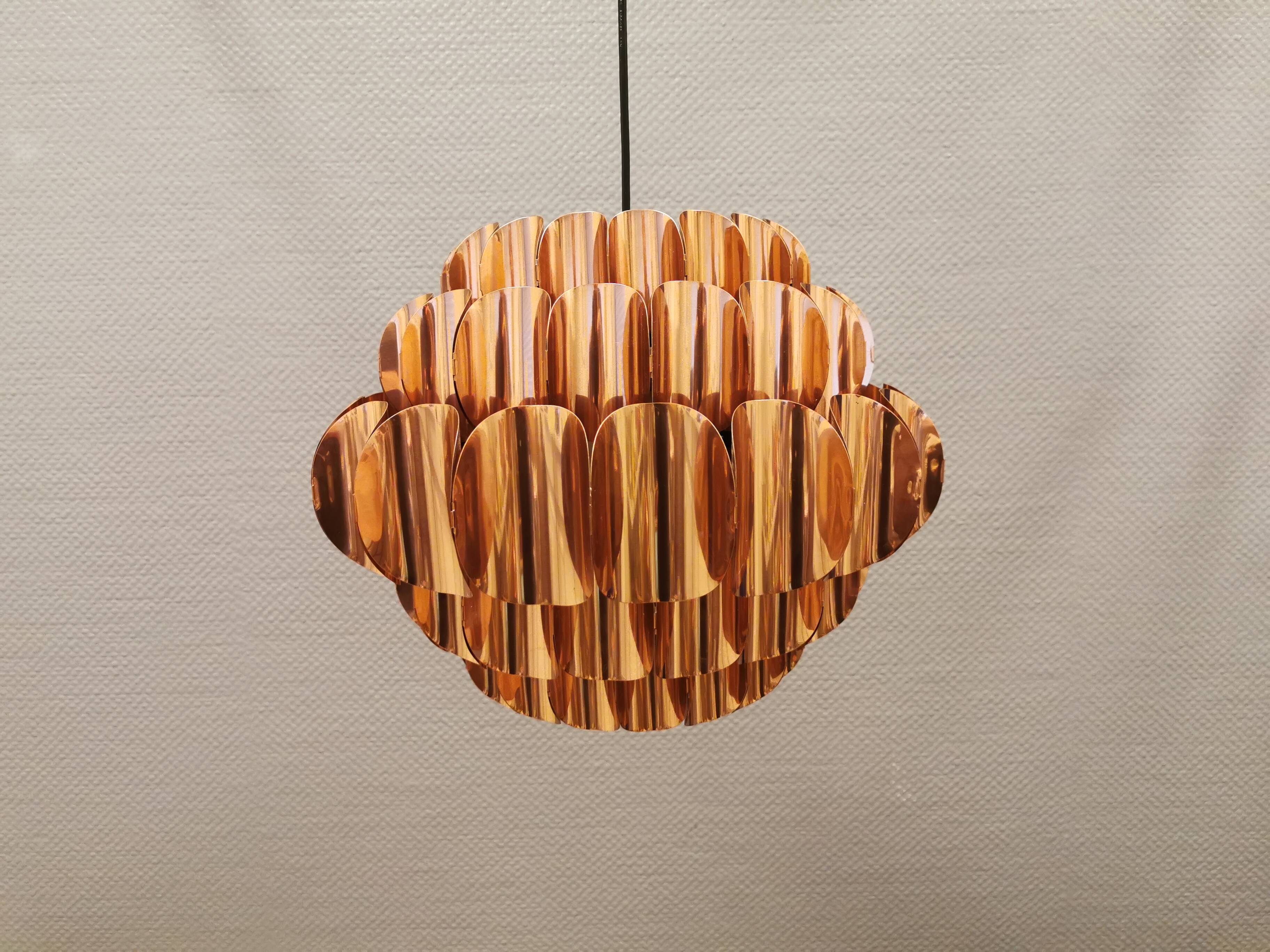 Copper colored hanging lamp. designed by thorsten orrling sweden
