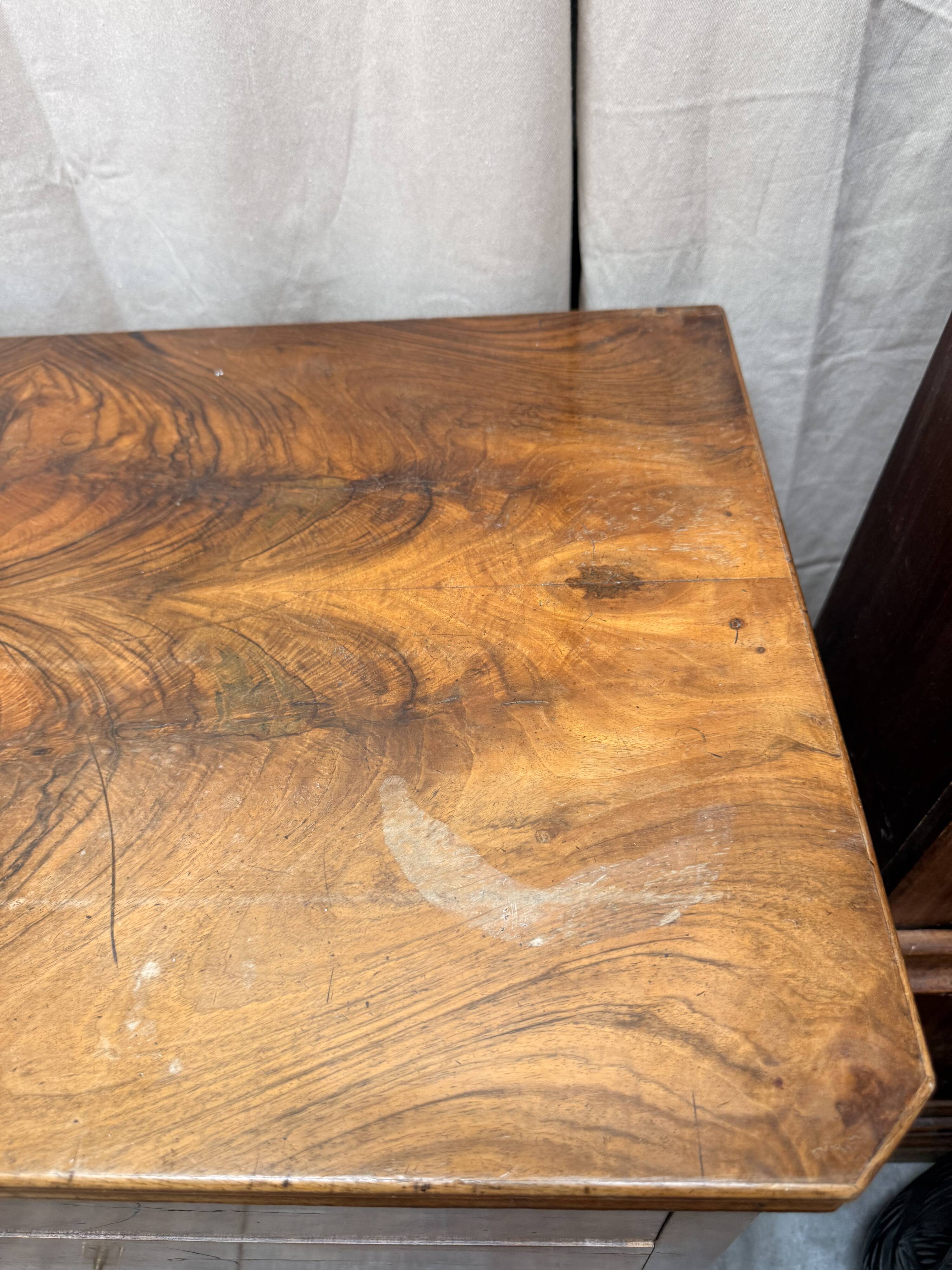 Antique English commode in flame walnut.
