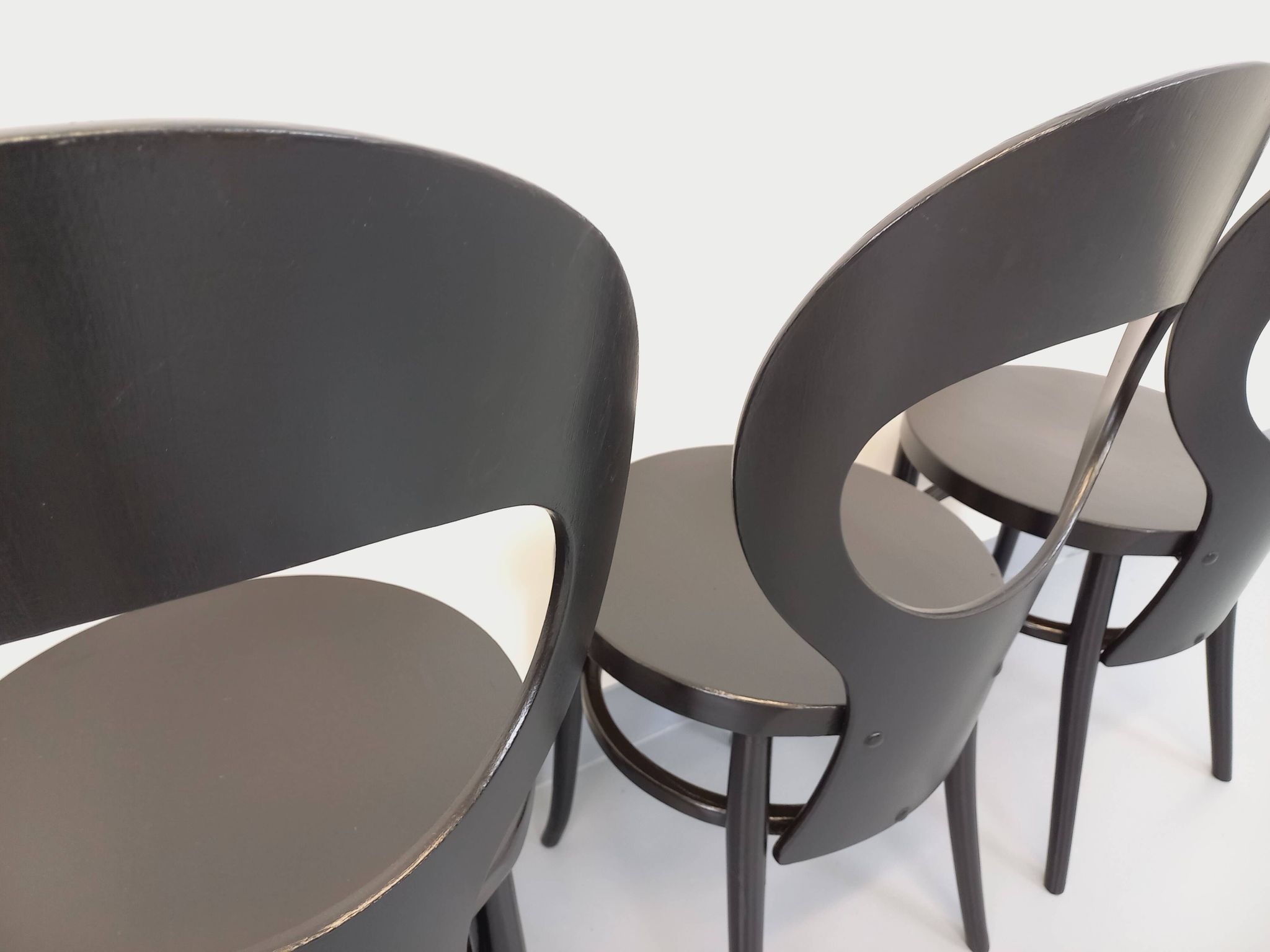 Set of 4 vintage Mouette chairs by Baumann in black wood from the 1960s.