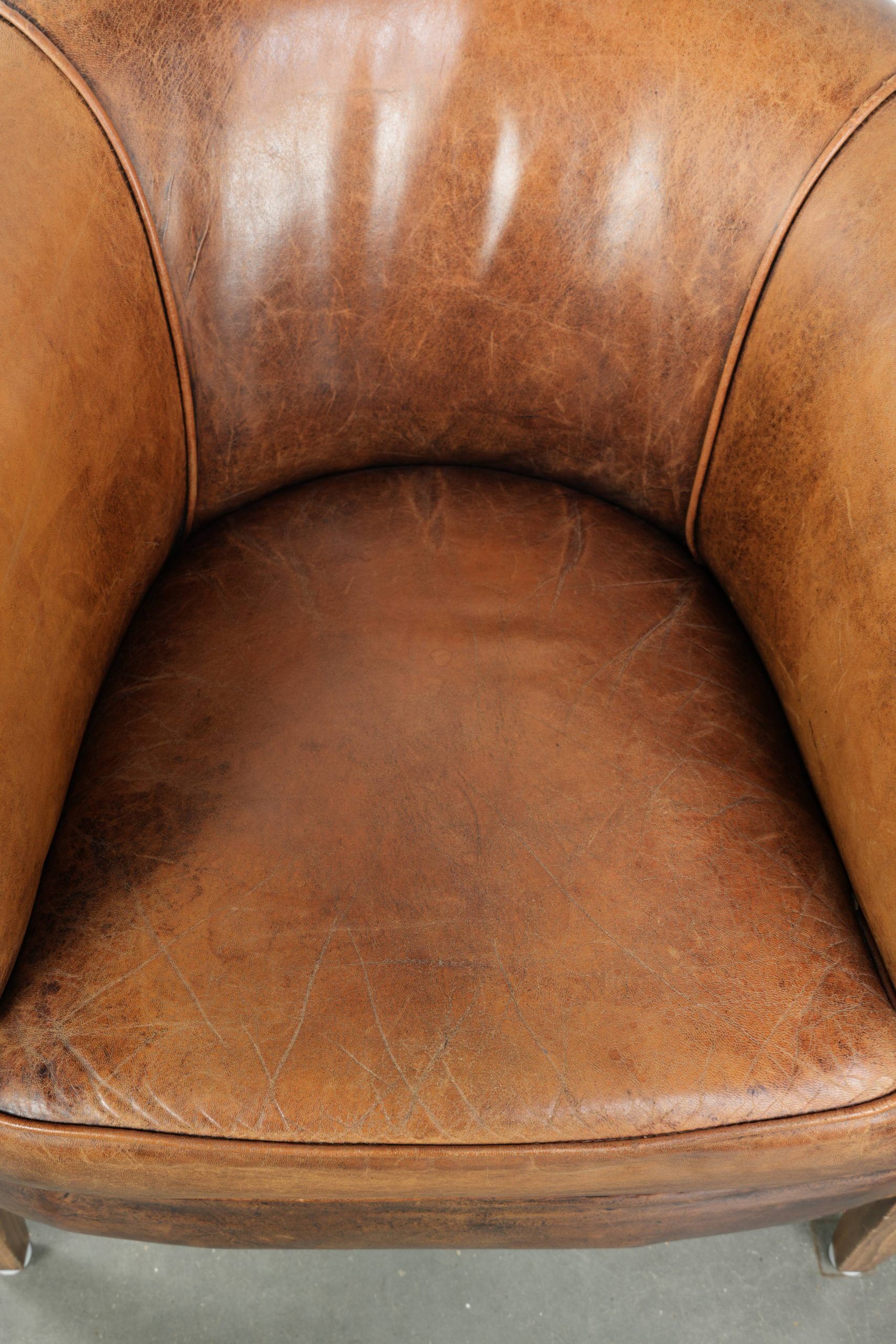 Vintage sheepskin club armchair in a subtle size with warm colours