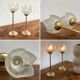 Pair of tulip-shaped candle holders in frosted glass and brass.