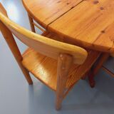 Suite of a round table with extension and 4 vintage pine chairs from the 60s and 70s