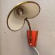 Danish red lacquered wall light with brass details. Estimated 1980s