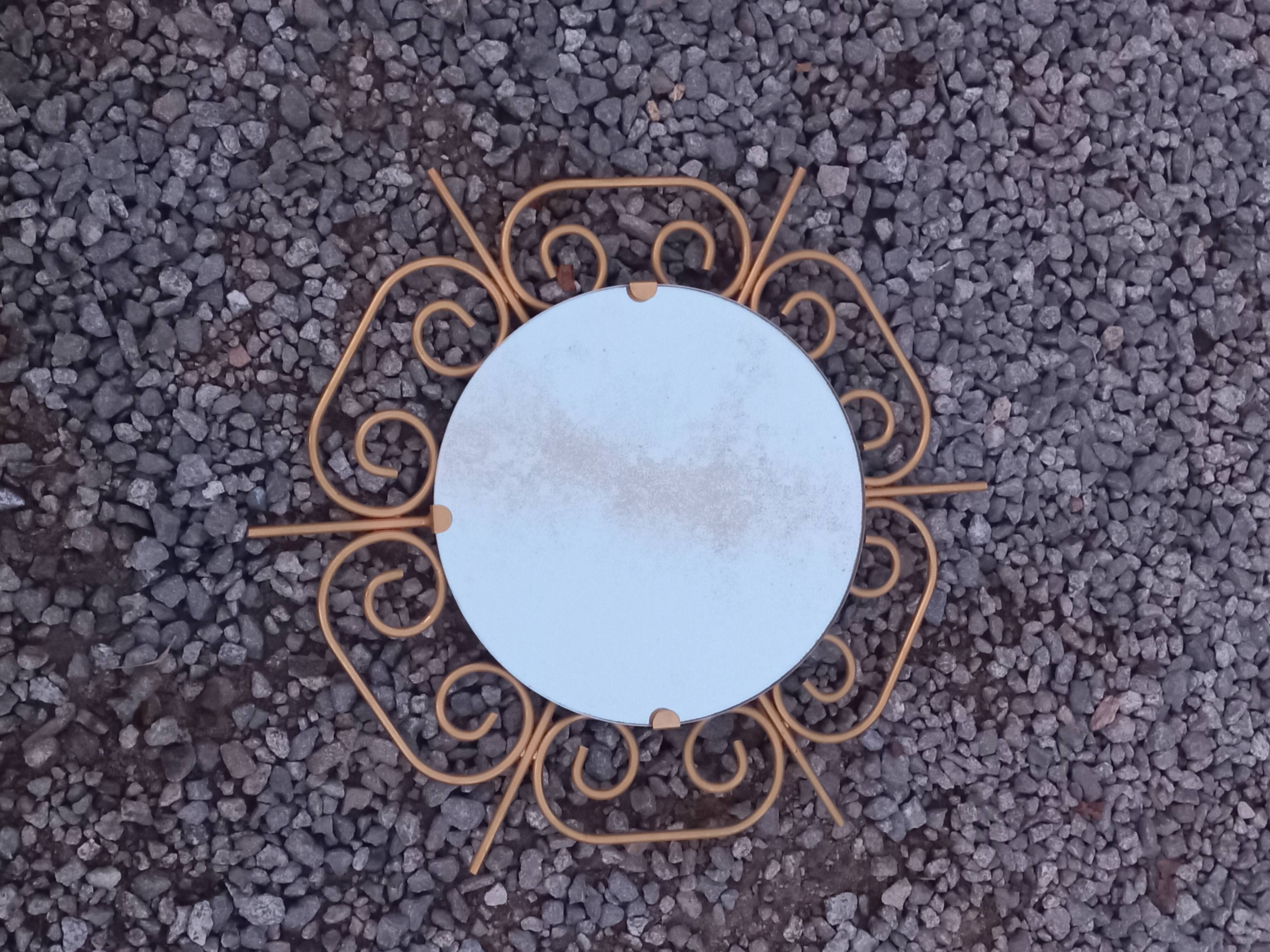 Golden metal sun mirror from the 1950s.