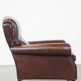 Comfortable and correct dark antique sheepskin English armchair in very good condition