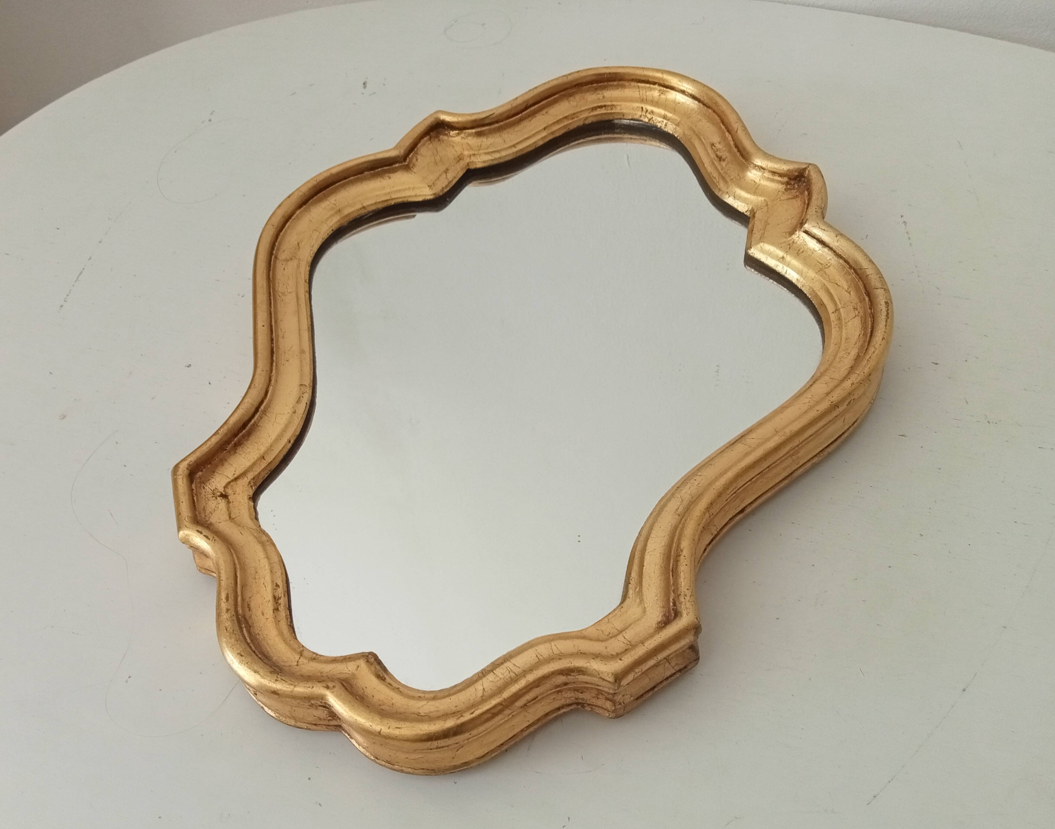 Baroque mirror in gilded wood from the 1960s.