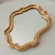 Baroque mirror in gilded wood from the 1960s.