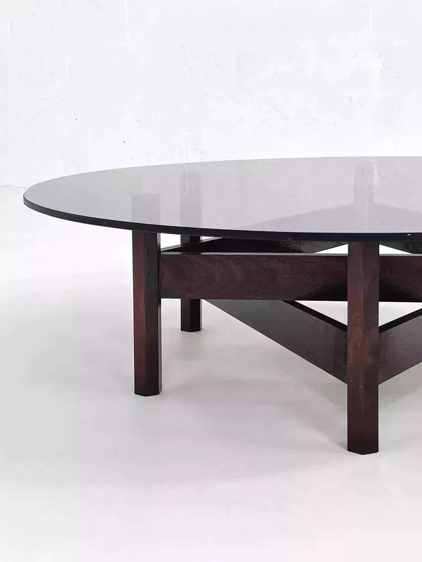 Wooden coffee table with round smoked glass top
