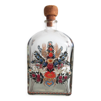 Bottle with folkloric decoration of flowers and birds inspired by Eastern countries