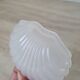 Scallop shell butter dish in stainless steel with its white glass saucer.
