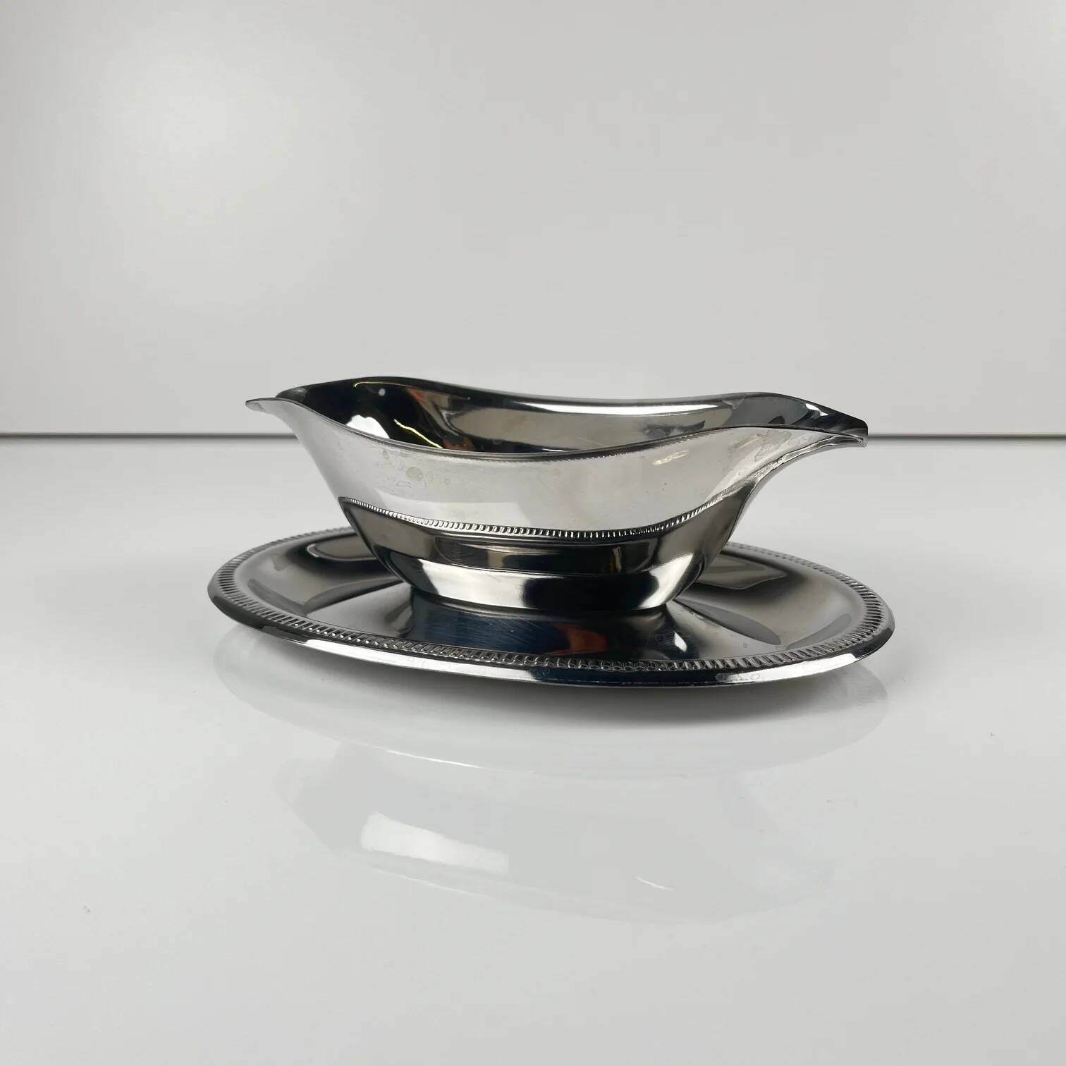 Metal sauceboat in Empire style, silver colour.