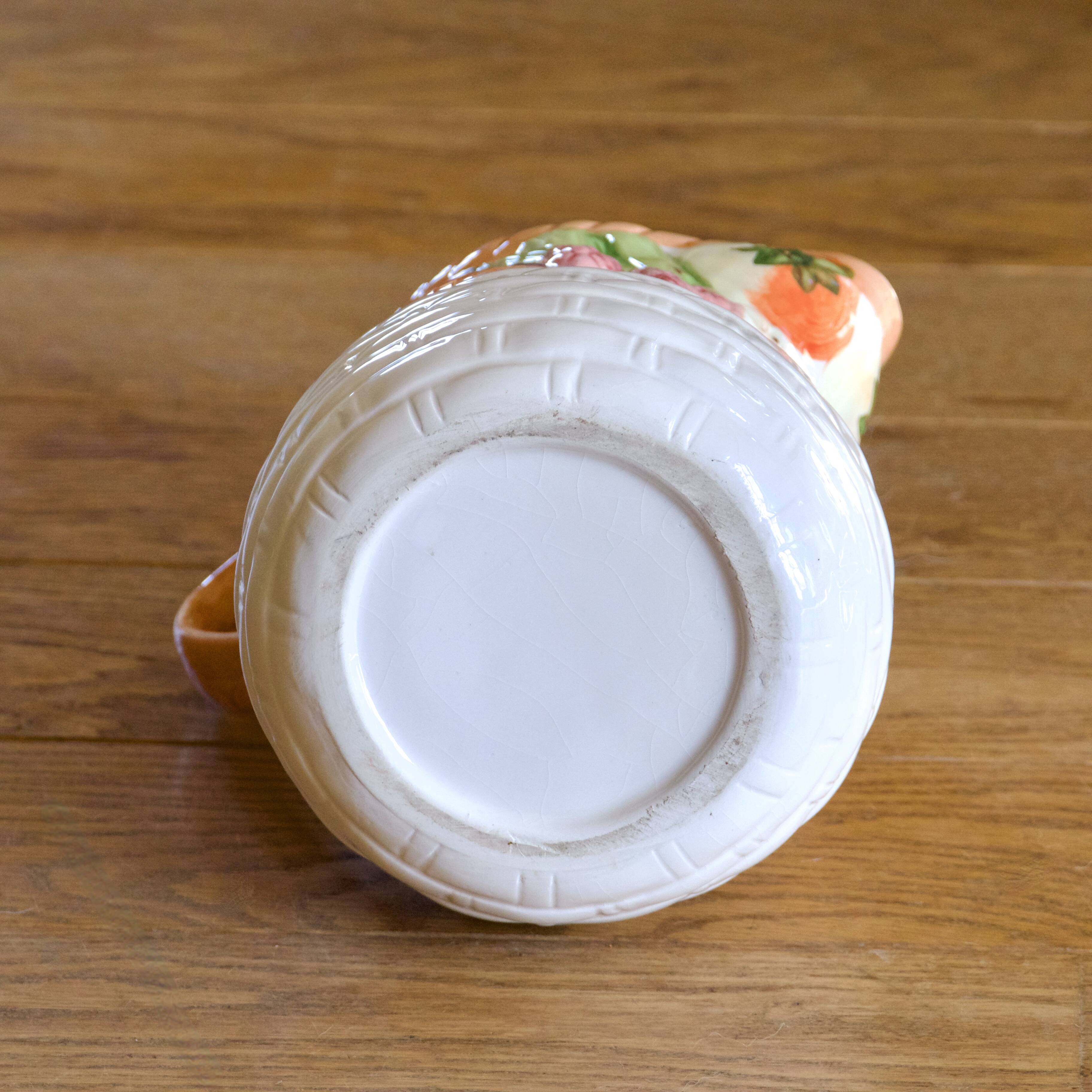 Hand-painted earthenware carafe with a raised vegetable basket design