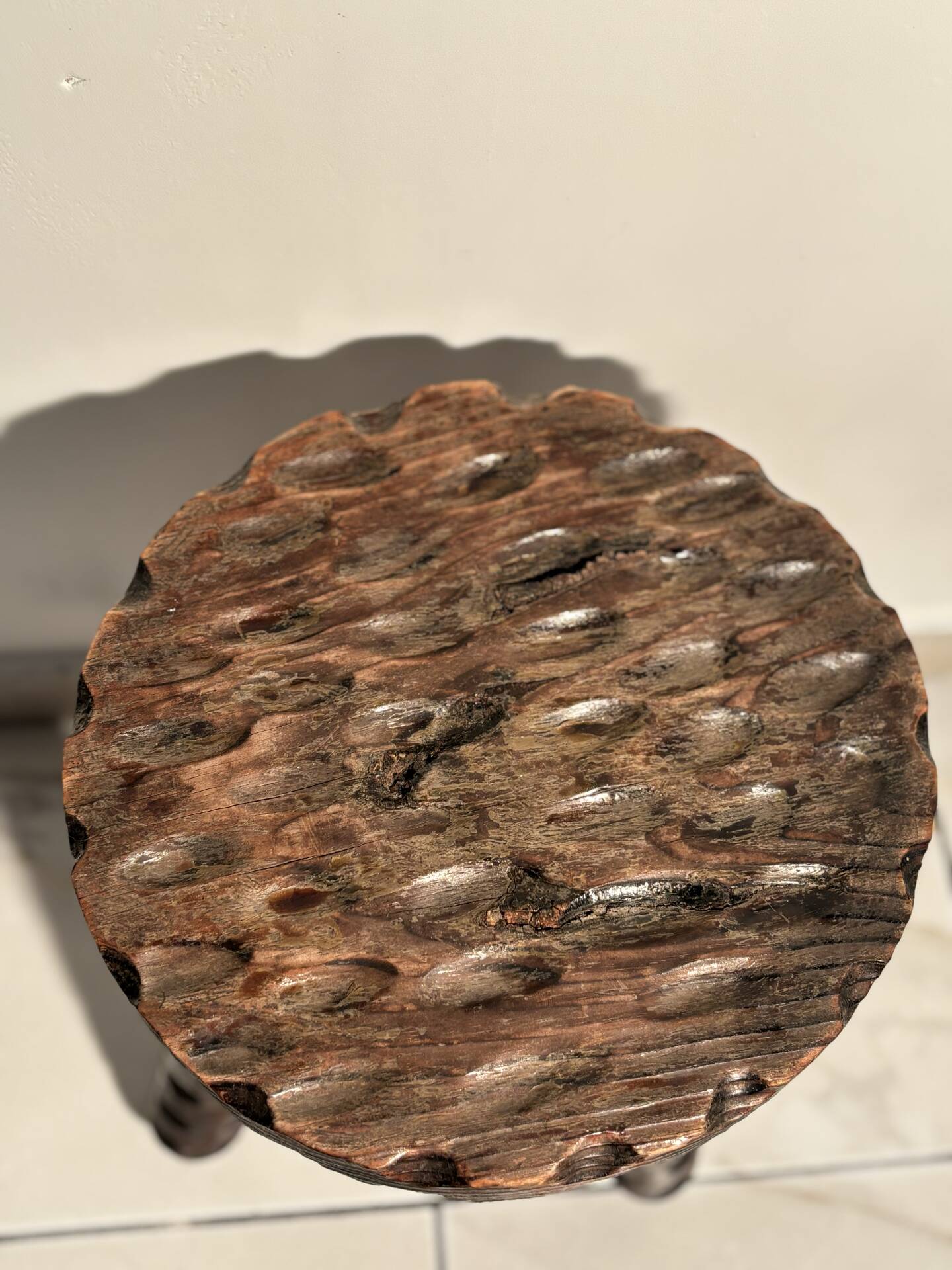 Brutalist sculpted tripod stool in solid wood — 1960s