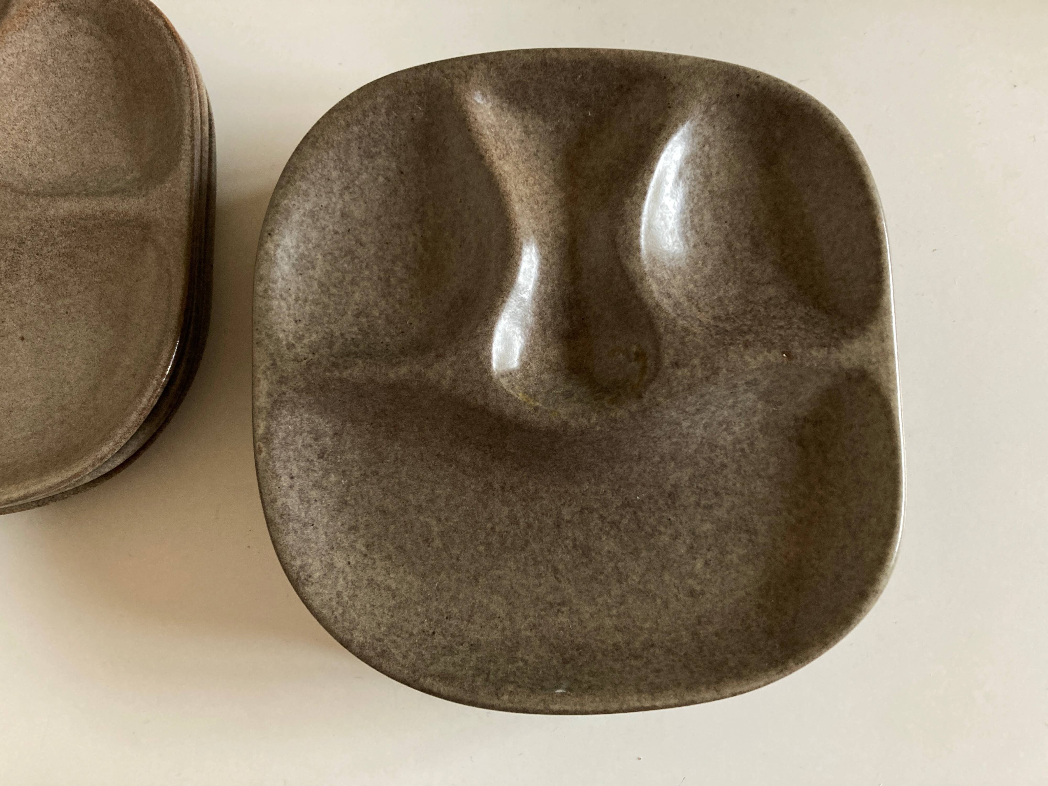 Set of 8 mid century modern stoneware potter's plates to identify