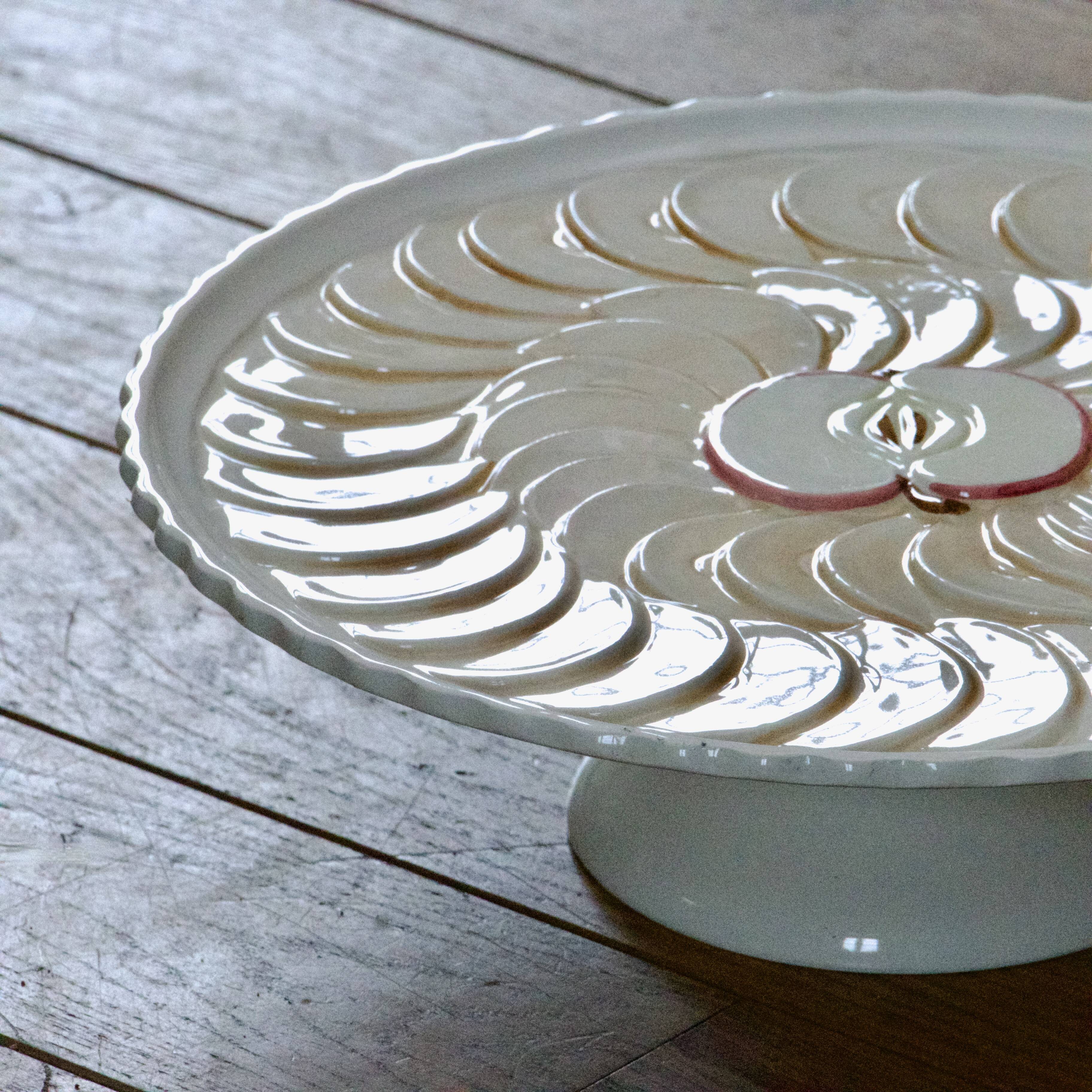 Large vintage earthenware pie dish on a pedestal, apple pie