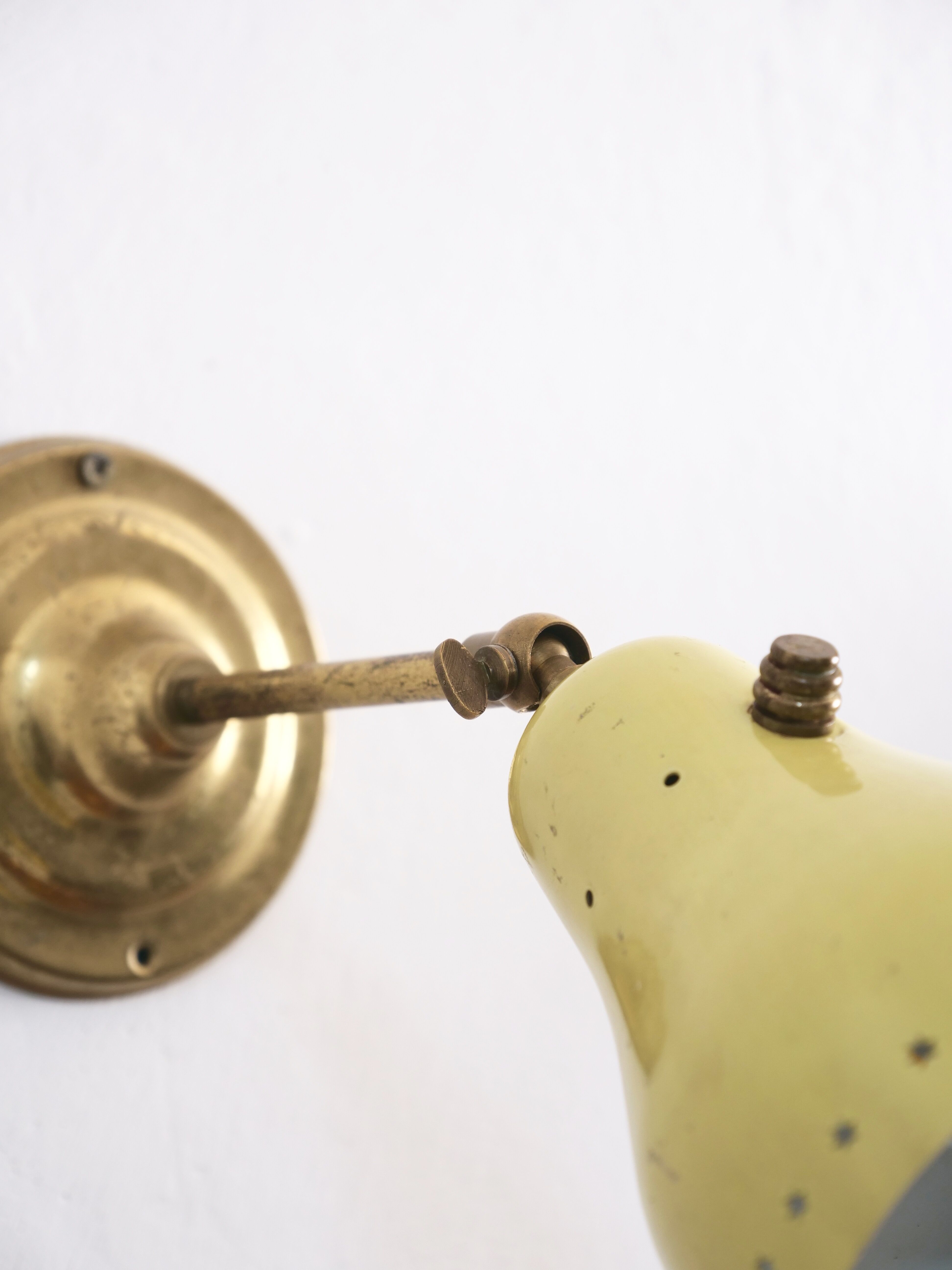 Wall lamp inlaiton and pale yellow lacquered metal