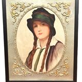 Old portrait of a young woman with braids and a hat, circa 1930