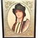 Old portrait of a young woman with braids and a hat, circa 1930