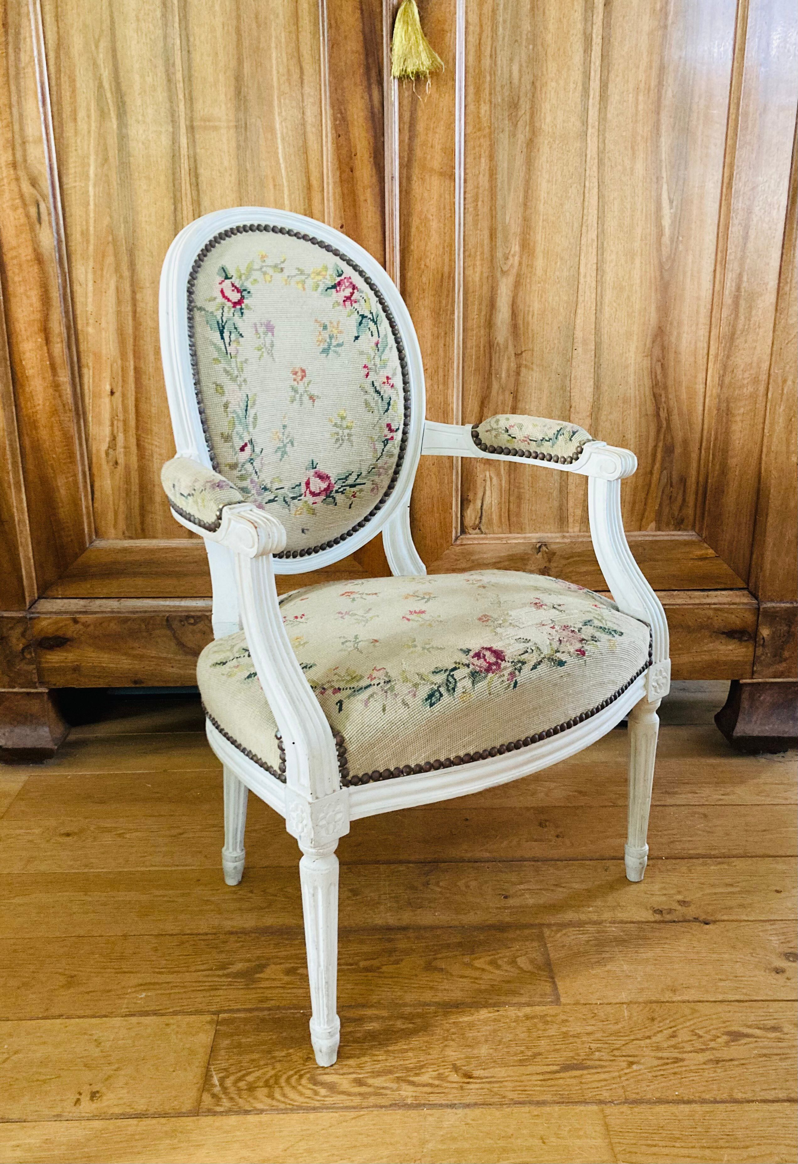Upholstered armchair with cross-stitch in the Louis XVI style, 19th century.