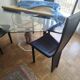 For sale: bevelled glass table and Artedi leather chairs.