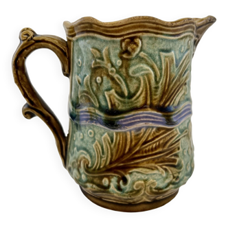 Earthenware slip pitcher decorated with aquatic plants