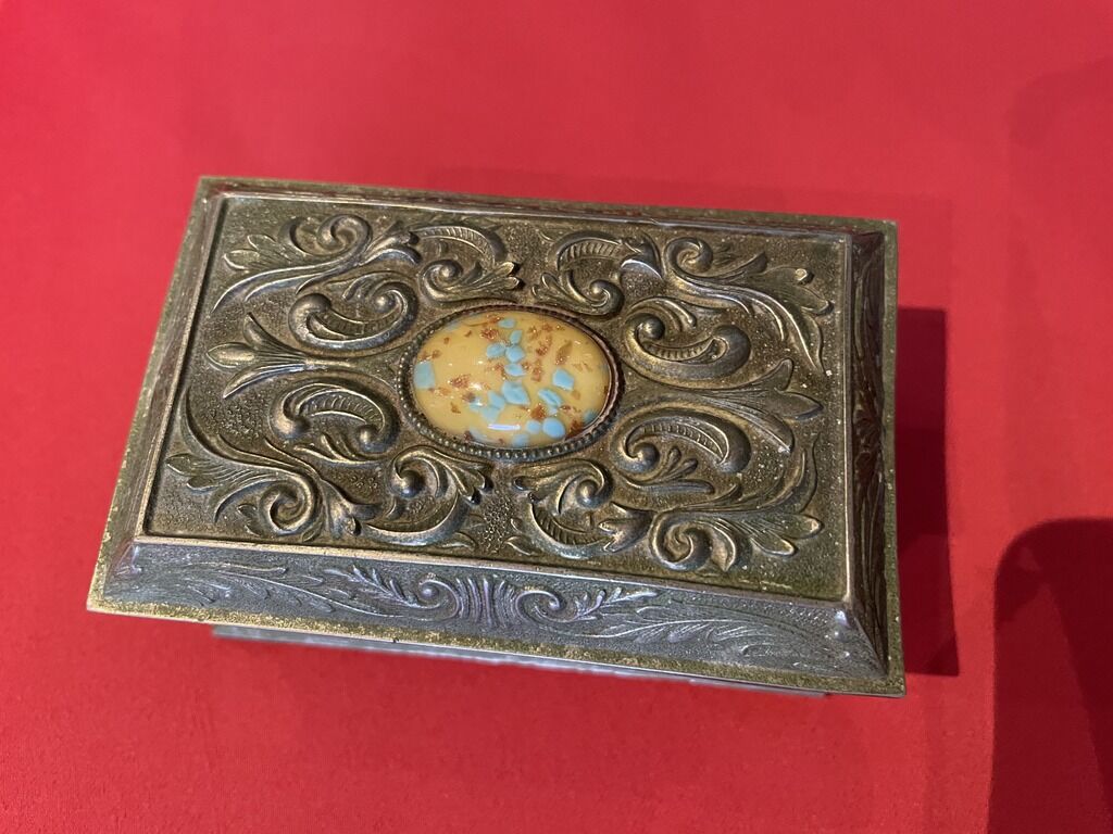 Ancient box made of chiseled metal and stone