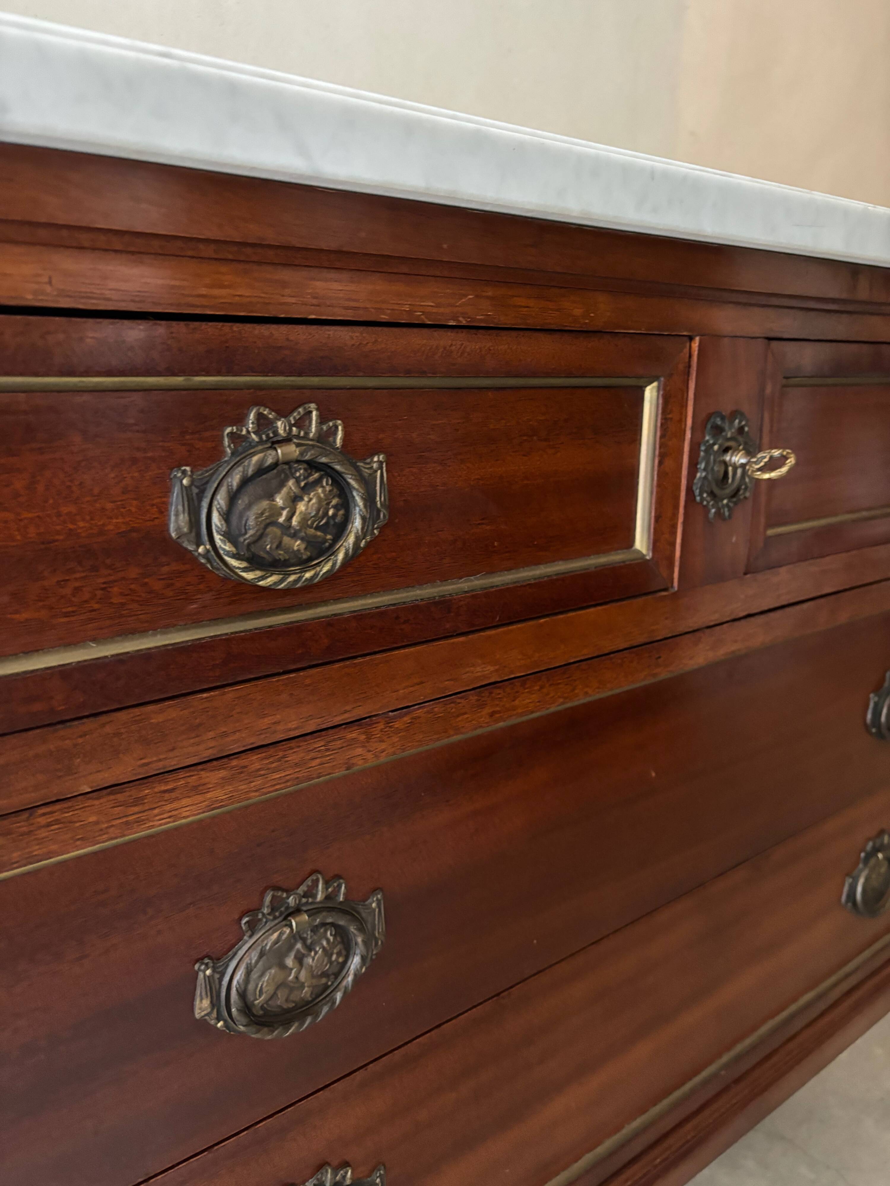 Louis XVI style commode with a shaped marble top.