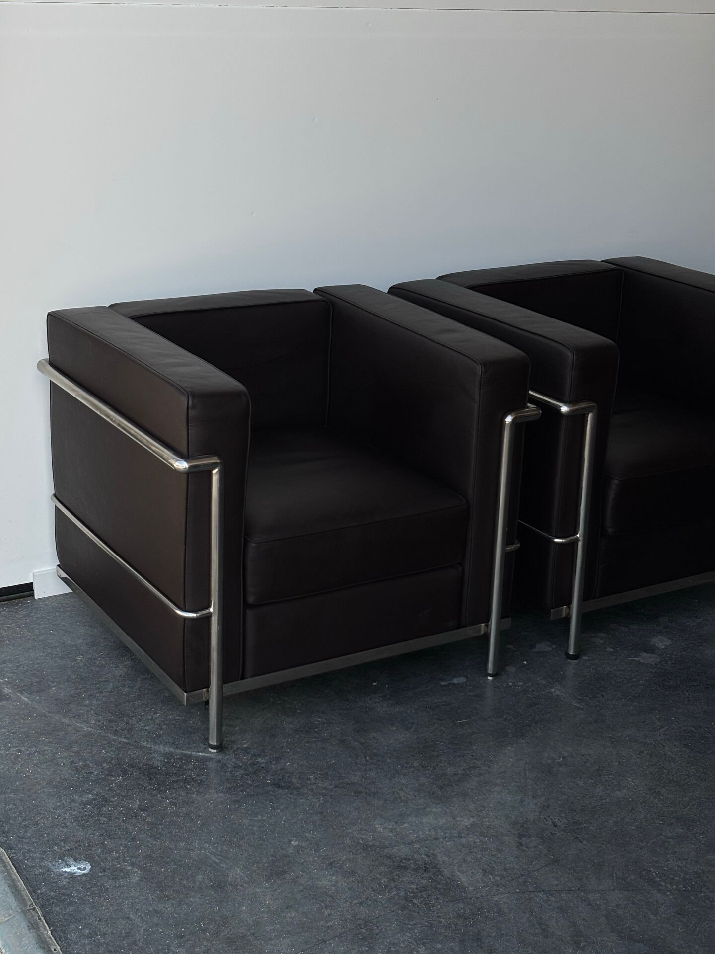 Pair of modernist brown leather armchairs