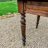 Old French farmhouse table in walnut with turned legs.