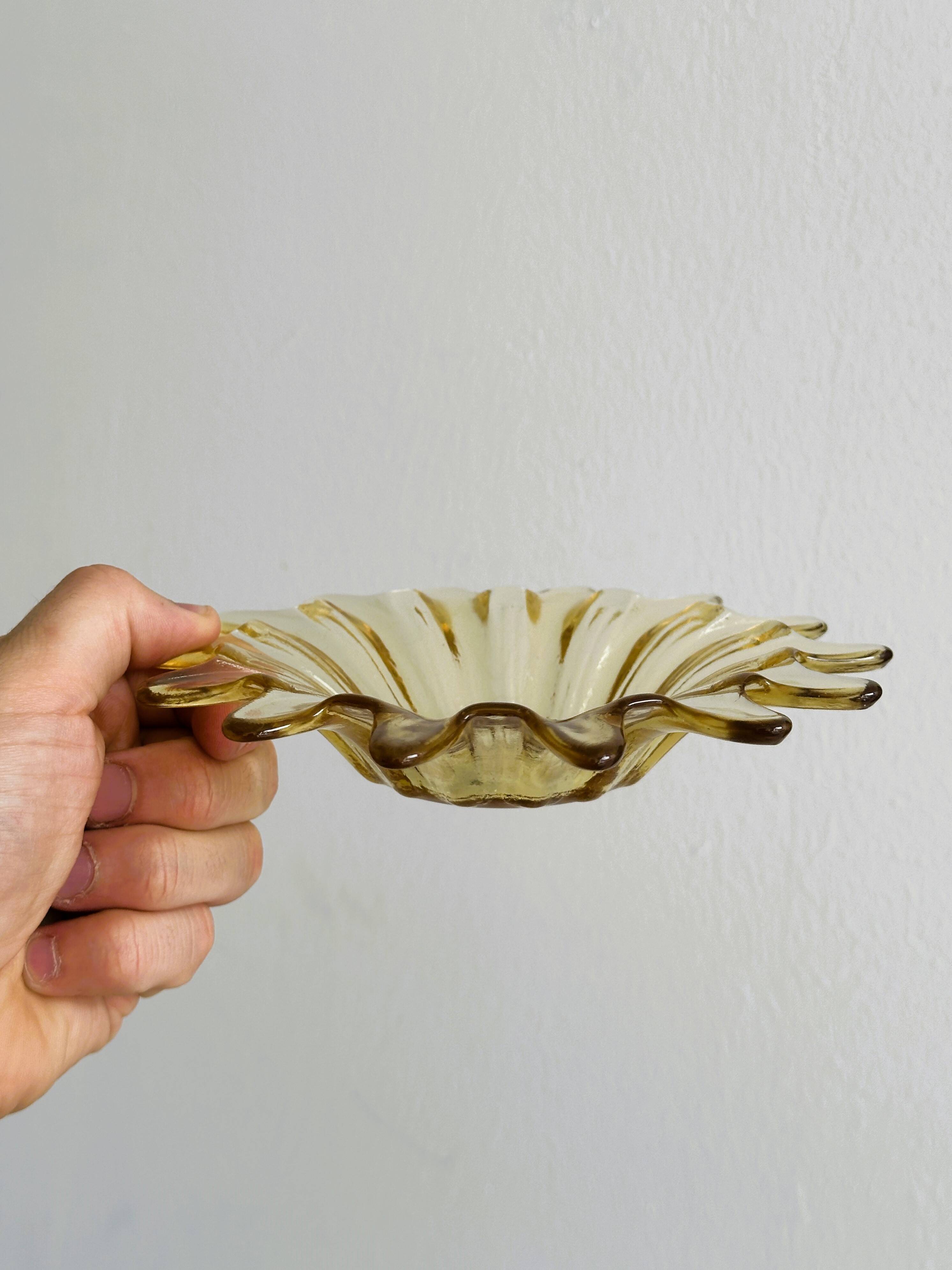 Empty pocket in yellow translucent blown glass, ashtray.