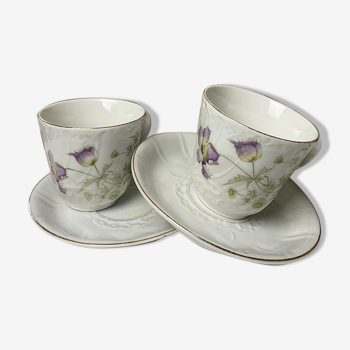 duo of porcelain cups and subcups floral motifs