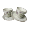 duo of porcelain cups and subcups floral motifs