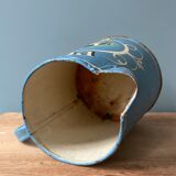 Old pitcher or milk jug in painted sheet metal