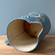 Old painted sheet metal jug or milk jug
