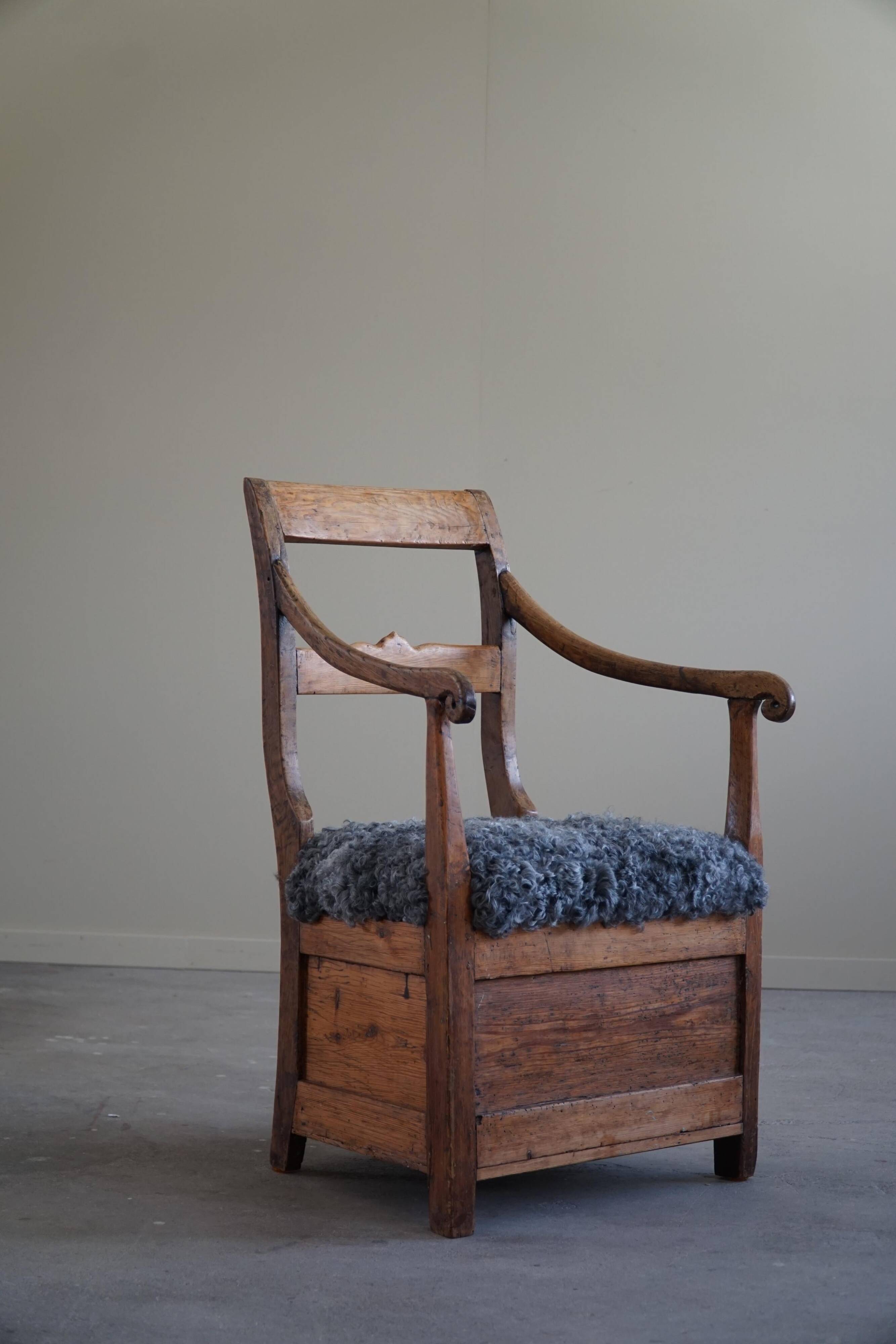 Danish popular art armchair in solid oak and Gotland sheep skin, mid-19th century.
