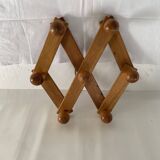 Foldable ball coat rack made of fir wood.