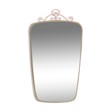 Antique free-form wall mirror with gilt frame and brass ornament