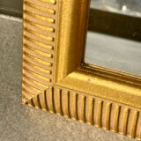 Mirror with striated and gilded decor