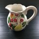 Fruit-decorated pitcher in slipware