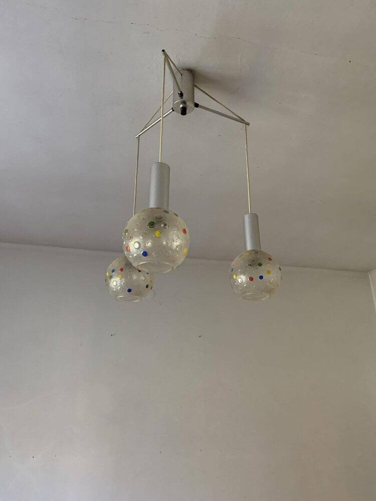 Vintage multicoloured glass sphere ceiling light with red dots and metal structure.
