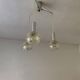 Vintage multicoloured glass sphere ceiling light with red dots and metal structure.