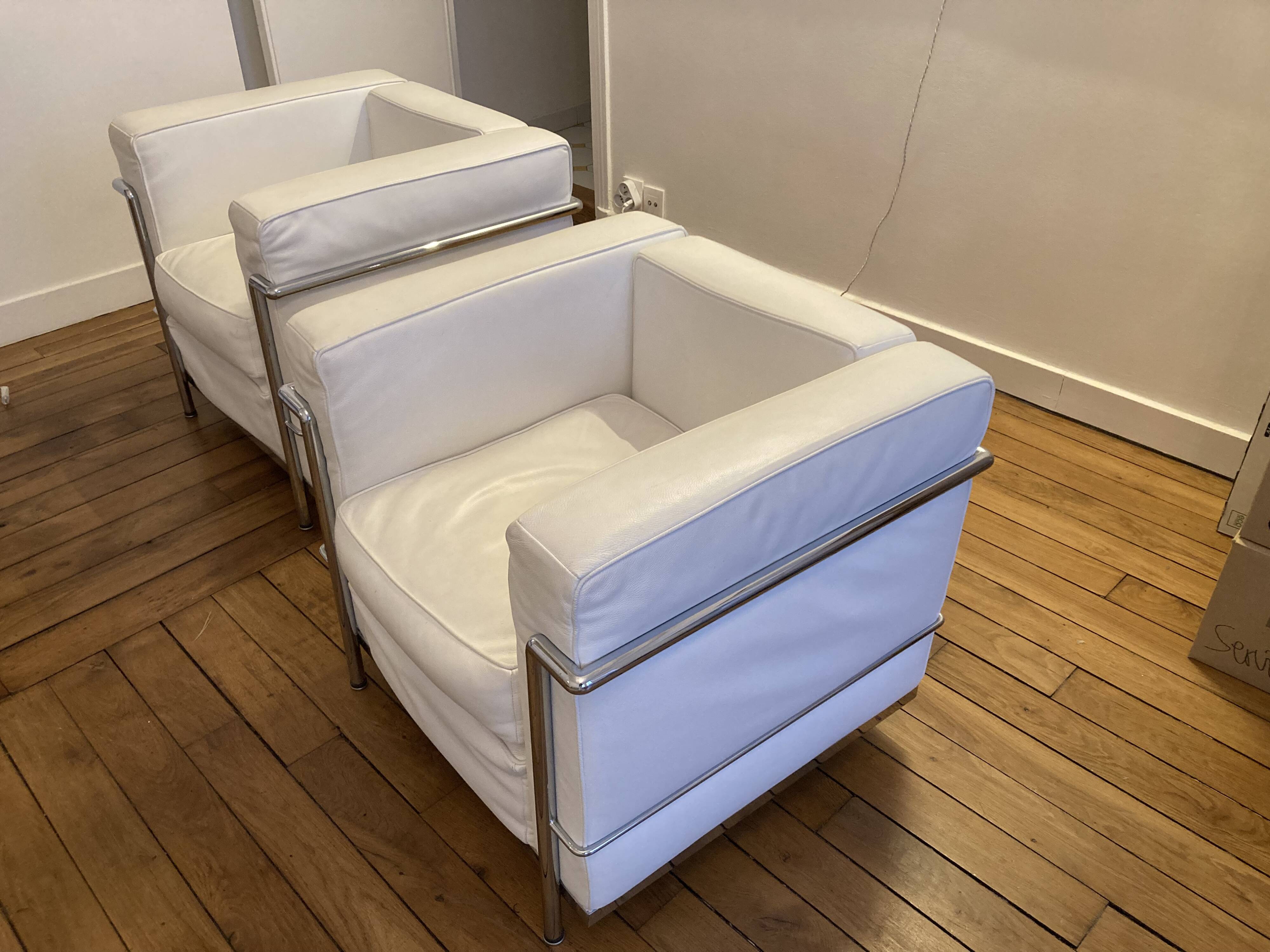 Pair of white leather and chrome armchairs