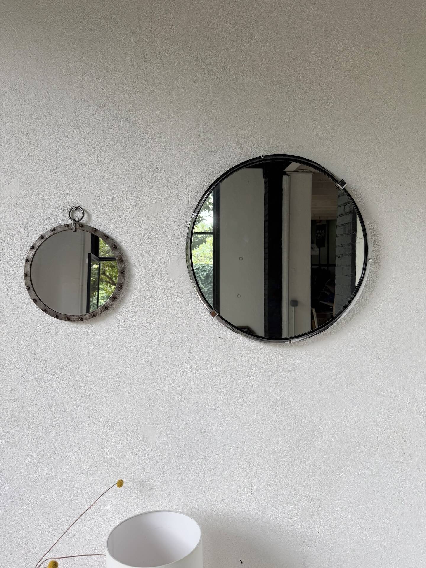 Brutalist round mirror with wrought iron and studs.