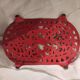 Vintage oval dark coral pink cast iron trivet