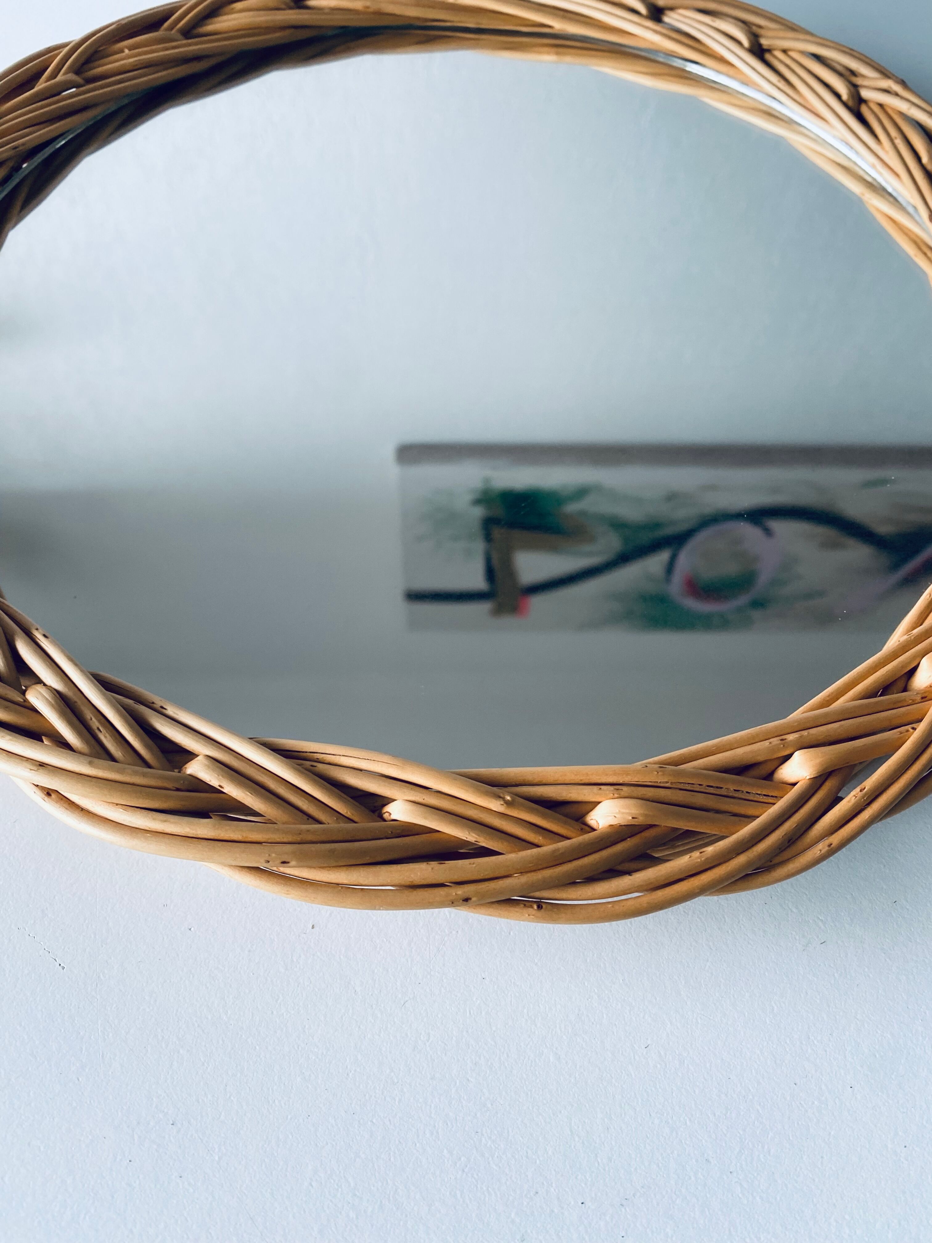 Round mirror in vintage wicker