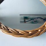 Round mirror in vintage wicker