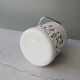 Vintage white opaline ice bucket with red patterns.