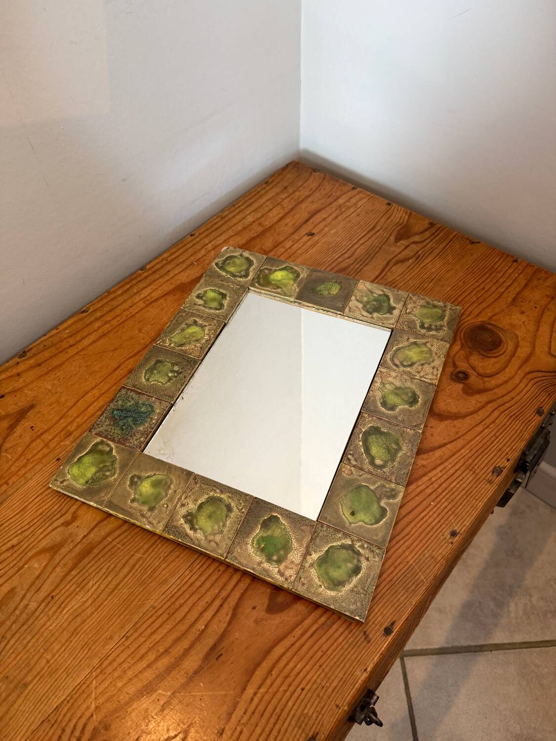 Vintage 1960s green and brown glazed ceramic mirror.